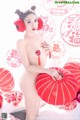 A naked asian woman holding a red umbrella.