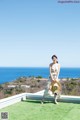 A woman standing on top of a lush green field.