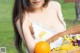 A woman holding a basket full of fruit and flowers.