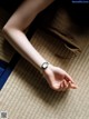 A woman's hand with a watch on her wrist.