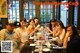 A group of people sitting around a long table.