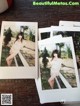 A couple of polaroids sitting on top of a wooden table.