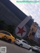 A yellow taxi parked in front of a large building.