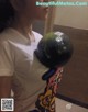 A woman holding a bowling ball in her hand.