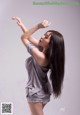 A woman with long black hair is posing for a picture.