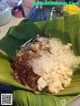 A plate of food on a banana leaf covered in ice.