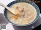 A bowl of porridge with a spoon in it.