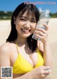 A woman in a yellow bikini holding a bottle of water.