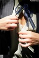 A close up of a woman's hands adjusting a jacket.