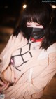 A woman wearing a face mask and a jacket.