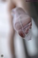 A close up of a person holding a piece of cloth in their hand.