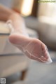 A close up of a person's foot with a pair of white socks.