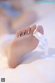 A close up of a person's foot with a white ribbon on it.