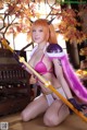 A woman in a pink bikini holding a sword.