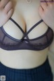 A close up of a woman wearing a purple bra.