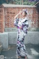 A woman in a kimono poses for a picture.