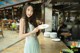 A woman holding a plate of food in a restaurant.