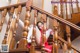 A woman in a red and white uniform is sitting on the stairs.