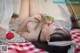 A woman laying on a blanket with flowers in her hair.