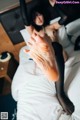 A woman laying on top of a bed with her feet up.