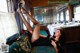 A woman laying on a couch in a train car.