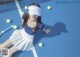 A woman laying on a tennis court with a racket and balls.