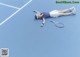 A woman laying on a tennis court with a racket.