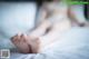 A woman laying on a bed with her bare feet.