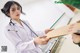 A woman in a white lab coat holding a piece of paper.