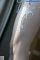 A close up of a woman's legs covered in cream.