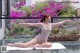 A woman in a leotard doing yoga on a yoga mat.